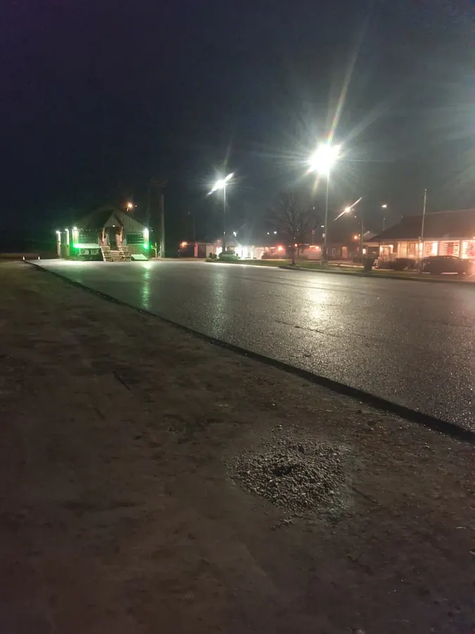Commercial asphalt paving project completed at night