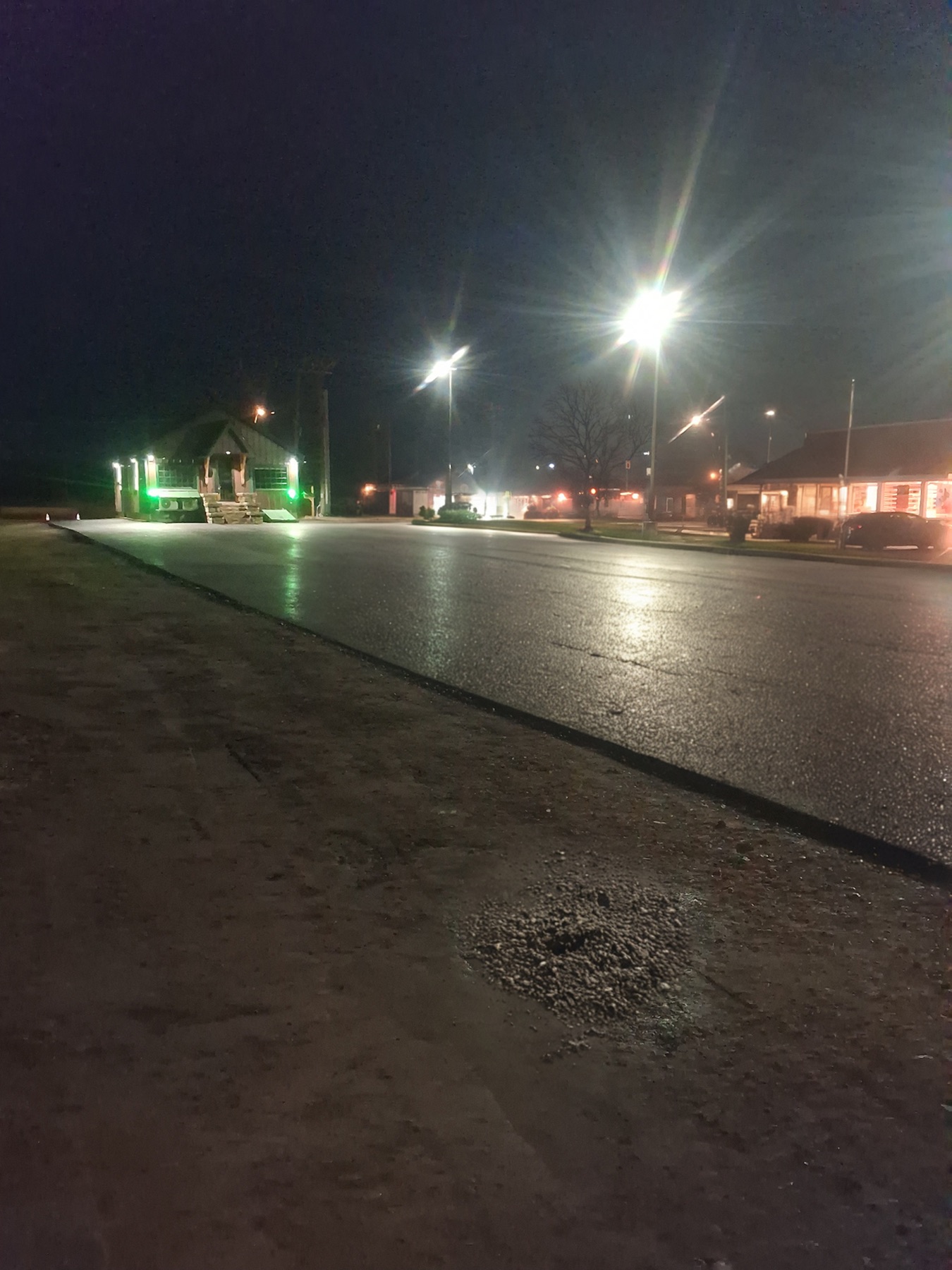 Fresh commercial asphalt paving completed at night